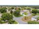 A peaceful residential street lined with well-kept homes, mature trees, and manicured lawns at 616 Hartford Ln, The Villages, FL 32162