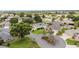 Overview of a quiet neighborhood featuring mature trees, landscaped yards, and well-maintained homes at 616 Hartford Ln, The Villages, FL 32162