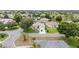 Aerial view of a single-Gathering home with a brick paver driveway and well-manicured landscaping at 616 Hartford Ln, The Villages, FL 32162