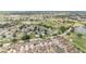 Overview of a vibrant residential area with lush greenery, a golf course, and scenic ponds at 616 Hartford Ln, The Villages, FL 32162