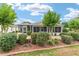 Green and landscaped backyard featuring a screened porch, patio, and mature plantings for added privacy at 616 Hartford Ln, The Villages, FL 32162