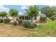 Lush backyard featuring a screened porch, landscaped borders, and green lawn for outdoor enjoyment at 616 Hartford Ln, The Villages, FL 32162