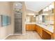 Bathroom featuring double vanity, step-in shower, and tile floors at 616 Hartford Ln, The Villages, FL 32162