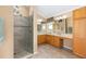 Bright bathroom featuring double vanity, step-in shower, and tile floors at 616 Hartford Ln, The Villages, FL 32162