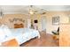 Spacious bedroom features tray ceiling, hardwood floors, and a ceiling fan at 616 Hartford Ln, The Villages, FL 32162