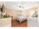 Charming bedroom with a ceiling fan, hardwood floors, and a window at 616 Hartford Ln, The Villages, FL 32162