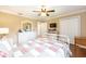 Bright bedroom featuring a ceiling fan, hardwood floors, and a window at 616 Hartford Ln, The Villages, FL 32162