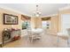 A charming dining room featuring a round table with seating for four, accented by a decorative chandelier at 616 Hartford Ln, The Villages, FL 32162