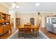Bright dining room with hardwood floors, wood furniture, and built in bookcases and hutch at 616 Hartford Ln, The Villages, FL 32162