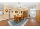 Light-filled dining room with wood table set, hardwood floors and hutch cabinet at 616 Hartford Ln, The Villages, FL 32162
