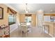 A cozy dining area with a white table and chairs, with views of the kitchen and natural light at 616 Hartford Ln, The Villages, FL 32162
