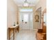 Inviting foyer with ceramic tile flooring, a decorative front door and lots of natural light at 616 Hartford Ln, The Villages, FL 32162