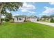 Well-maintained home with a lush green lawn, neatly trimmed bushes, and a brick-paved driveway at 616 Hartford Ln, The Villages, FL 32162