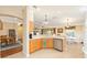 Spacious kitchen with stainless dishwasher and granite countertops open to dining area at 616 Hartford Ln, The Villages, FL 32162