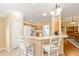 Kitchen showcasing granite countertops, gas range, and breakfast bar seating at 616 Hartford Ln, The Villages, FL 32162