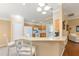 Kitchen showcasing granite countertops, gas range, and breakfast bar seating at 616 Hartford Ln, The Villages, FL 32162