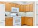 Bright kitchen featuring gas range, built-in microwave, and light wood cabinets at 616 Hartford Ln, The Villages, FL 32162