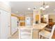 Kitchen showcasing granite countertops, gas range, and breakfast bar seating at 616 Hartford Ln, The Villages, FL 32162