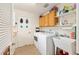 Laundry room equipped with modern appliances, sink, and ample storage space at 616 Hartford Ln, The Villages, FL 32162