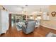 A bright and airy living space with modern furniture, hardwood floors, and access to outdoor seating at 616 Hartford Ln, The Villages, FL 32162