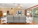 Comfortable living room with stylish furnishings, hardwood floors, and view of the lanai at 616 Hartford Ln, The Villages, FL 32162