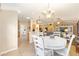 Open-concept living space with dining area, kitchen, and living room with comfortable seating at 616 Hartford Ln, The Villages, FL 32162