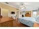 Bright main bedroom with hardwood floors, ceiling fan, and plenty of space for relaxation at 616 Hartford Ln, The Villages, FL 32162