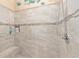 Modern tile step-in shower with a mosaic accent and bench at 616 Hartford Ln, The Villages, FL 32162