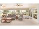 Relaxing sunroom with comfortable seating, ceiling fans, and large windows offering serene views at 616 Hartford Ln, The Villages, FL 32162