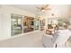 Bright sunroom featuring neutral furniture and multiple ceiling fans, perfect for relaxation and entertaining at 616 Hartford Ln, The Villages, FL 32162