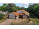 Aerial view showcasing a charming home with a brick driveway and a well-maintained lawn at 6259 Se 120Th Pl, Belleview, FL 34420