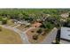 Aerial view of a single story home surrounded by lush greenery and a paved driveway at 6259 Se 120Th Pl, Belleview, FL 34420