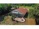 Aerial view of a backyard with a screened porch, patio and firepit sitting area at 6259 Se 120Th Pl, Belleview, FL 34420