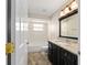 Bathroom featuring a granite countertop, dark cabinets, a tiled shower, and a bath tub at 6259 Se 120Th Pl, Belleview, FL 34420