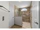 Bathroom shower featuring custom tile work, grab bars and semi-circular window at 6259 Se 120Th Pl, Belleview, FL 34420