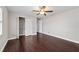 A bedroom with dark wood floors, a ceiling fan, a window, and a closet at 6259 Se 120Th Pl, Belleview, FL 34420