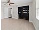 Bright bedroom features stylish tile flooring and a custom shelving unit at 6259 Se 120Th Pl, Belleview, FL 34420