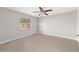 Bright bedroom features a large window and stylish tile flooring at 6259 Se 120Th Pl, Belleview, FL 34420