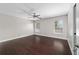 Spacious bedroom features dark wood flooring and a ceiling fan for added comfort at 6259 Se 120Th Pl, Belleview, FL 34420