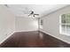 Bright bedroom featuring two windows and stylish dark wood flooring at 6259 Se 120Th Pl, Belleview, FL 34420