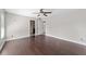 Bright bedroom features dark wood flooring, ceiling fan, and multiple entryways at 6259 Se 120Th Pl, Belleview, FL 34420