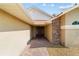 Inviting home entrance with brick accents, a paved walkway, and a well-maintained landscape at 6259 Se 120Th Pl, Belleview, FL 34420