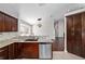 Well-equipped kitchen with stainless steel dishwasher, granite countertops, and dark cabinets at 6259 Se 120Th Pl, Belleview, FL 34420