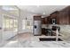 Kitchen with stainless steel appliances, granite countertops, and access to the sunroom at 6259 Se 120Th Pl, Belleview, FL 34420