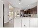 Open kitchen with stainless steel appliances, granite countertops, and a large pass-through bar to the dining room at 6259 Se 120Th Pl, Belleview, FL 34420
