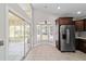 Bright kitchen featuring stainless steel appliances, a sunroom, and tiled floors at 6259 Se 120Th Pl, Belleview, FL 34420