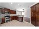 Renovated kitchen with modern appliances, granite countertops, and a view into the dining room at 6259 Se 120Th Pl, Belleview, FL 34420