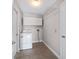 Functional laundry room featuring a washer, dryer, tile floors, and overhead storage at 6259 Se 120Th Pl, Belleview, FL 34420