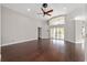 Spacious living room featuring hardwood floors, large windows, and a ceiling fan at 6259 Se 120Th Pl, Belleview, FL 34420