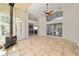 Bright sunroom with tile flooring, ceiling fan, wood burning stove and lots of natural light at 6259 Se 120Th Pl, Belleview, FL 34420